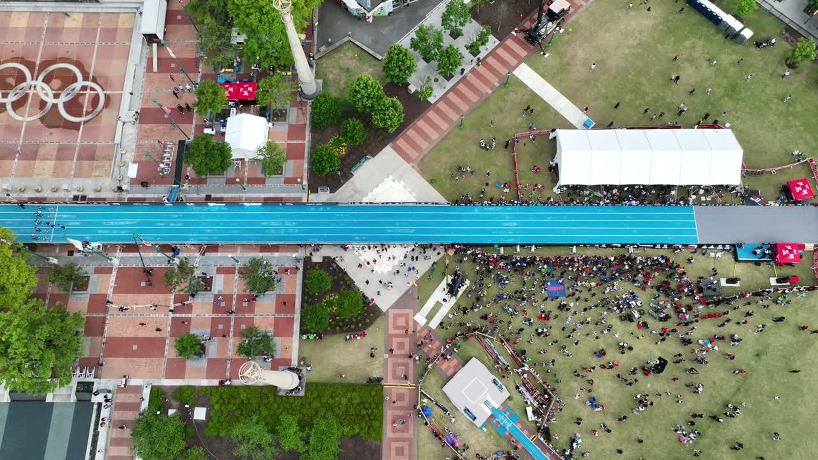 Overhead aerial view of an event site with crowds and pathways