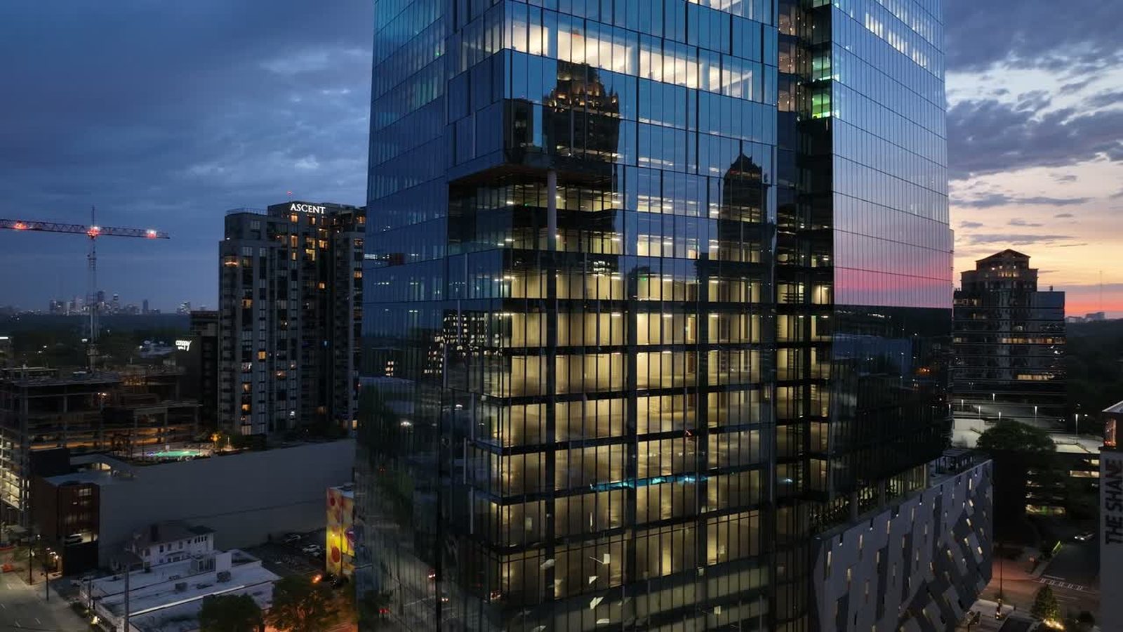 Glass office tower at dusk photographed from the air for a 3D capture