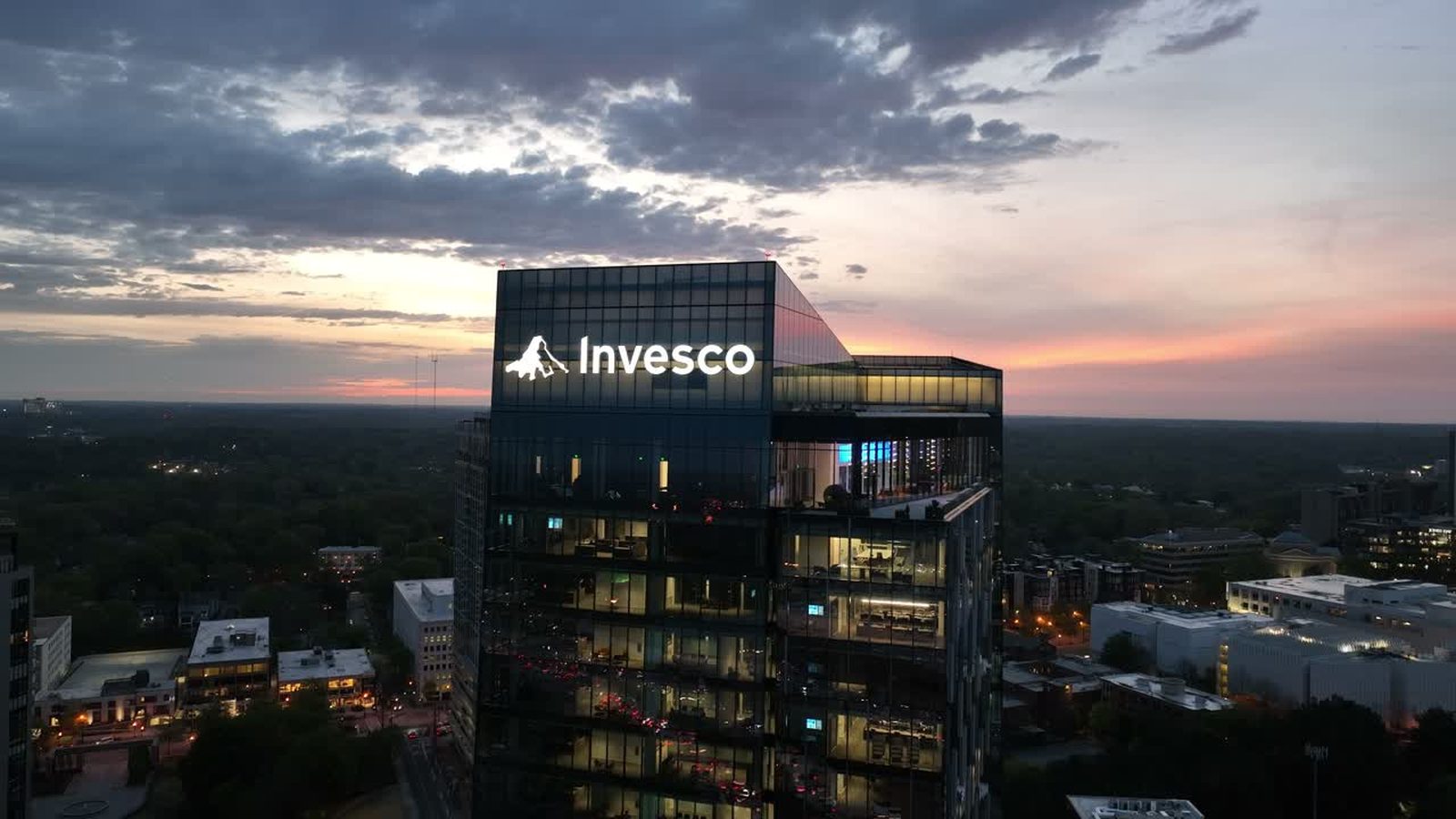Midtown Atlanta office tower lit at blue hour seen from the air
