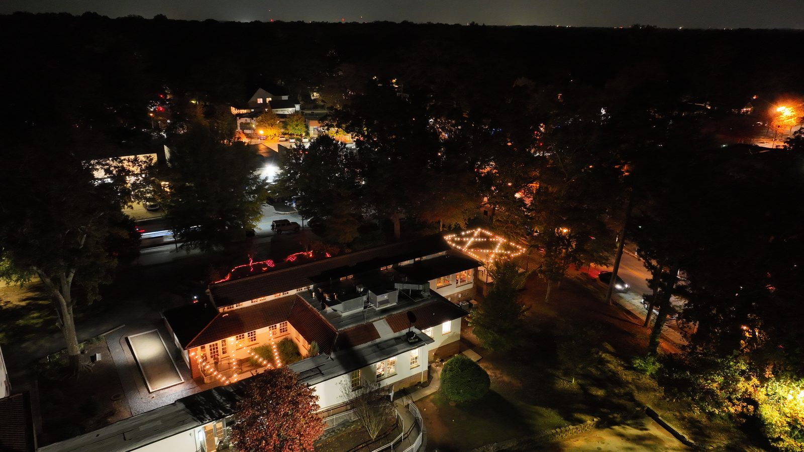 Night aerial view of lit houses and streets in an Atlanta neighbourhood