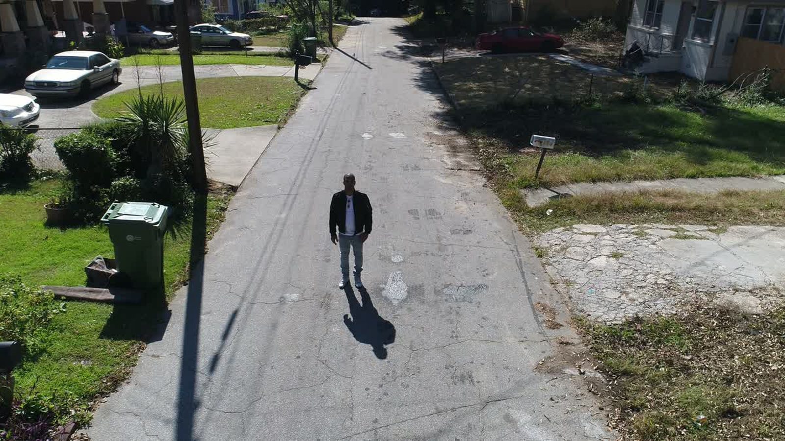 Low aerial view along a residential street with a person walking