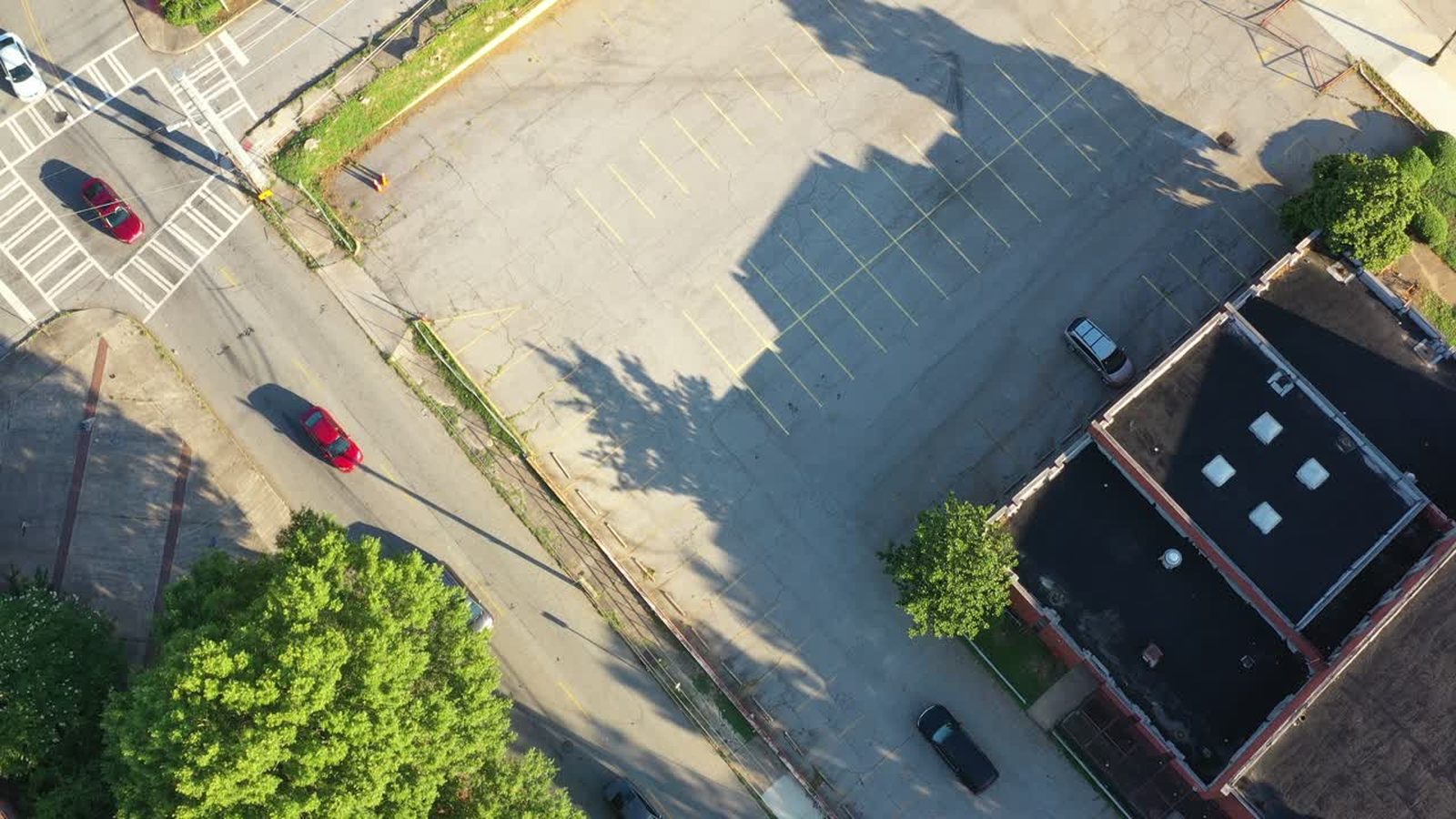 Overhead aerial view of rooftop mechanical equipment and parking below