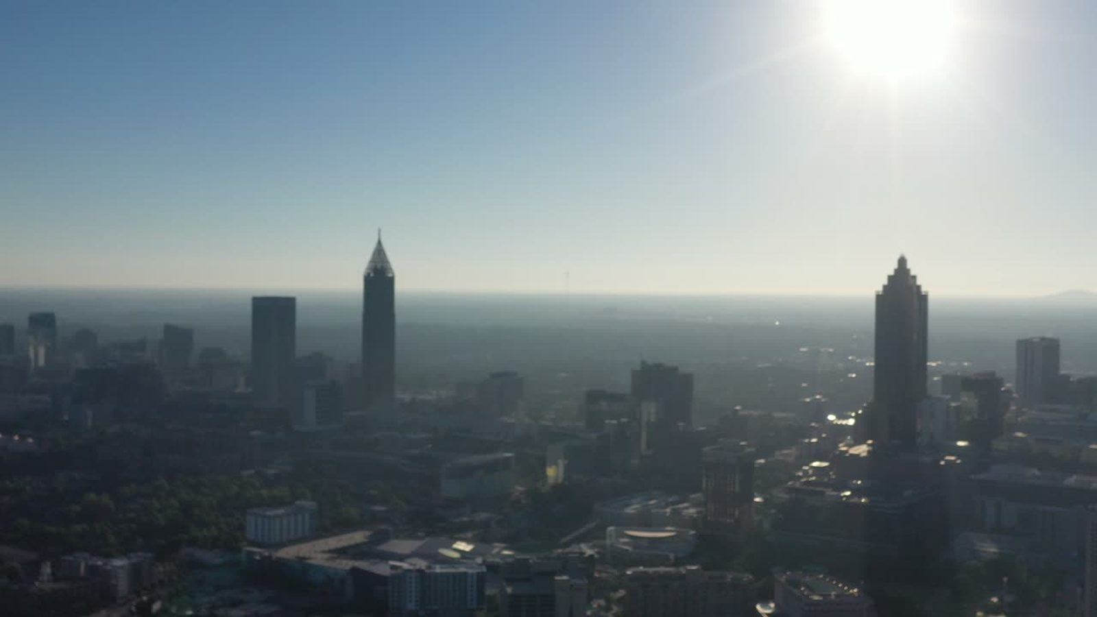 Sunlit aerial view over Atlanta with strong glare from the midday sun